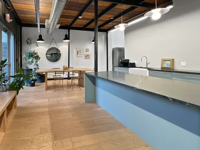 a view of a kitchen with a sink and cabinets