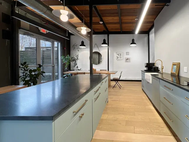 a large kitchen with kitchen island a large window