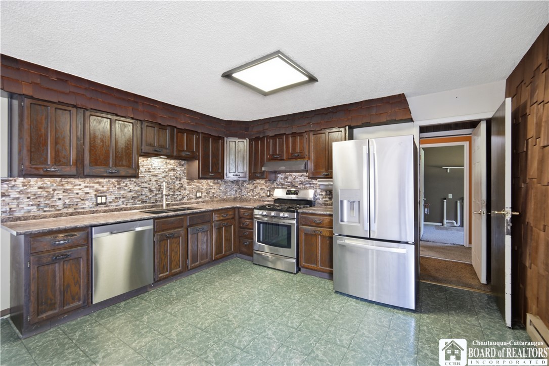 425 Brigham Road Dunkirk, NY 14048 - Photo 6 of 31 Stainless appliances and updated tile backsplash i