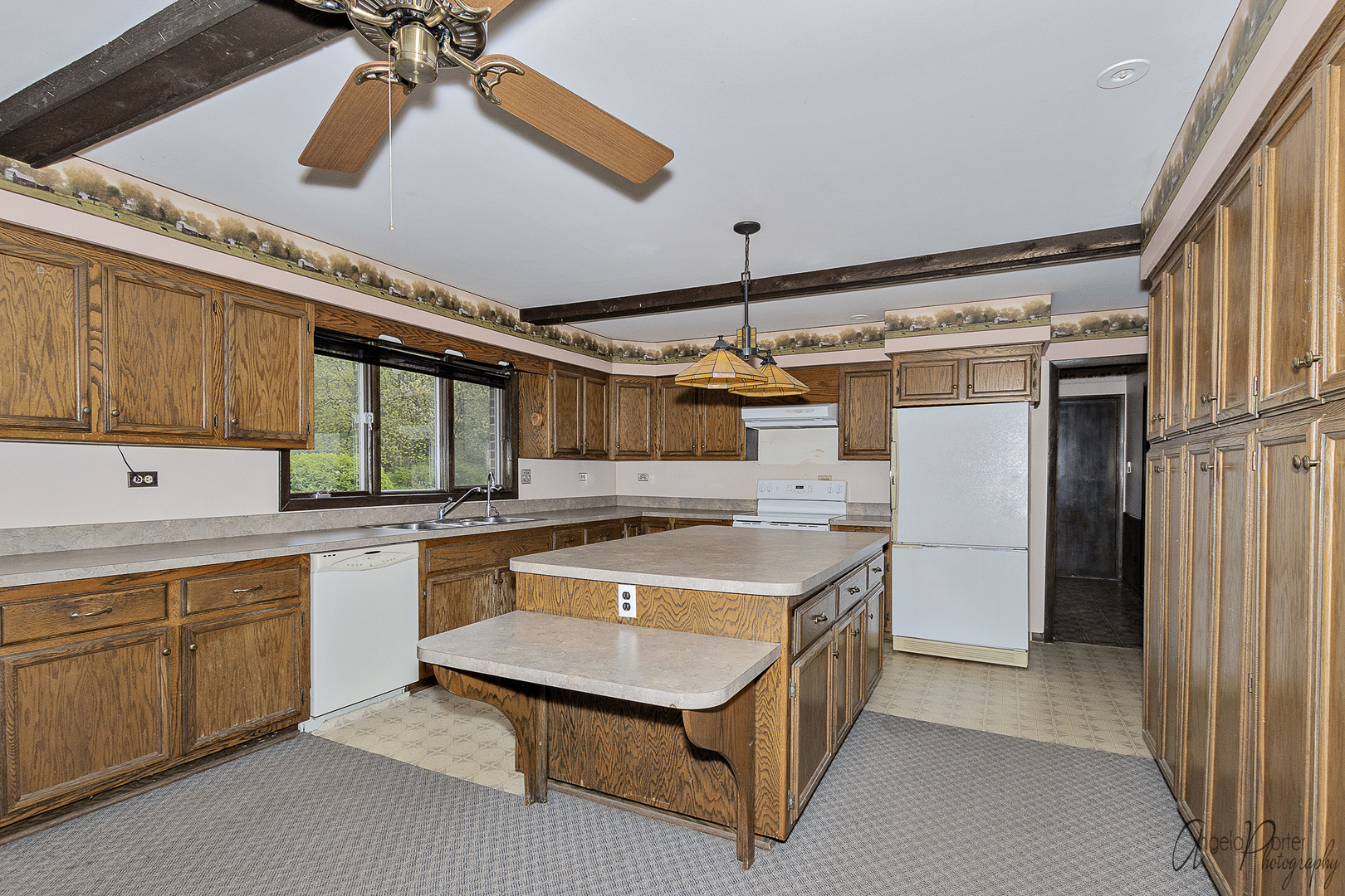 9920 Voss Road Marengo, IL 60152 - Photo 10 of 41 a kitchen with a sink a stove and cabinets