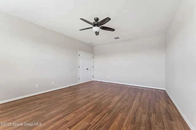 a bathroom with a granite countertop sink mirror vanity and toilet