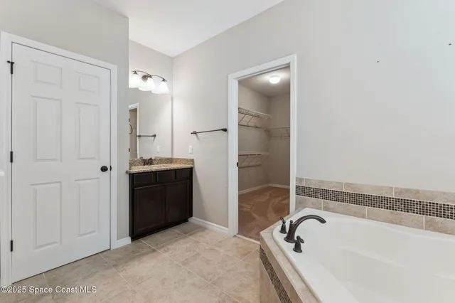 a bathroom with a granite countertop sink a toilet and shower