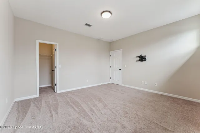 a view of room with wooden floor and ceiling fan