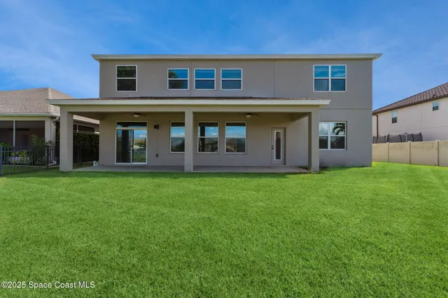 an aerial view of a house with a swimming pool