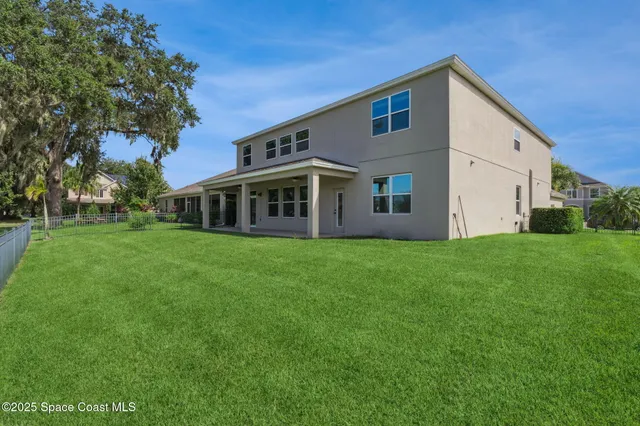 an aerial view of residential houses with outdoor space and swimming pool