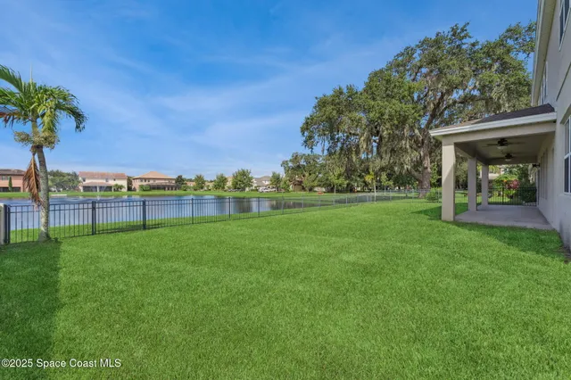 a backyard of a house with lots of green space and plants