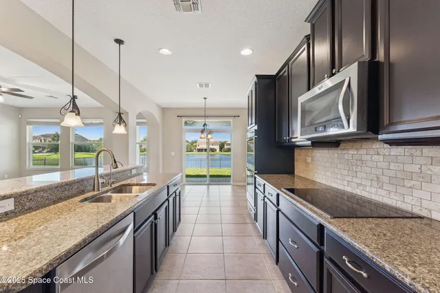 a kitchen with stainless steel appliances a refrigerator and a sink