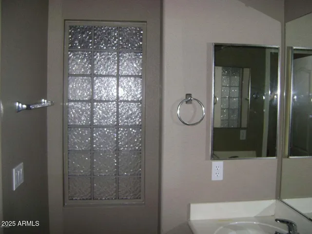 a bathroom with a glass shower door