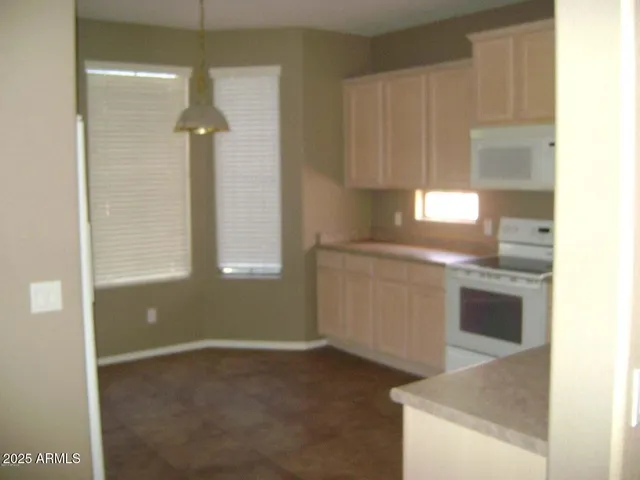 a kitchen with a stove and a white cabinet