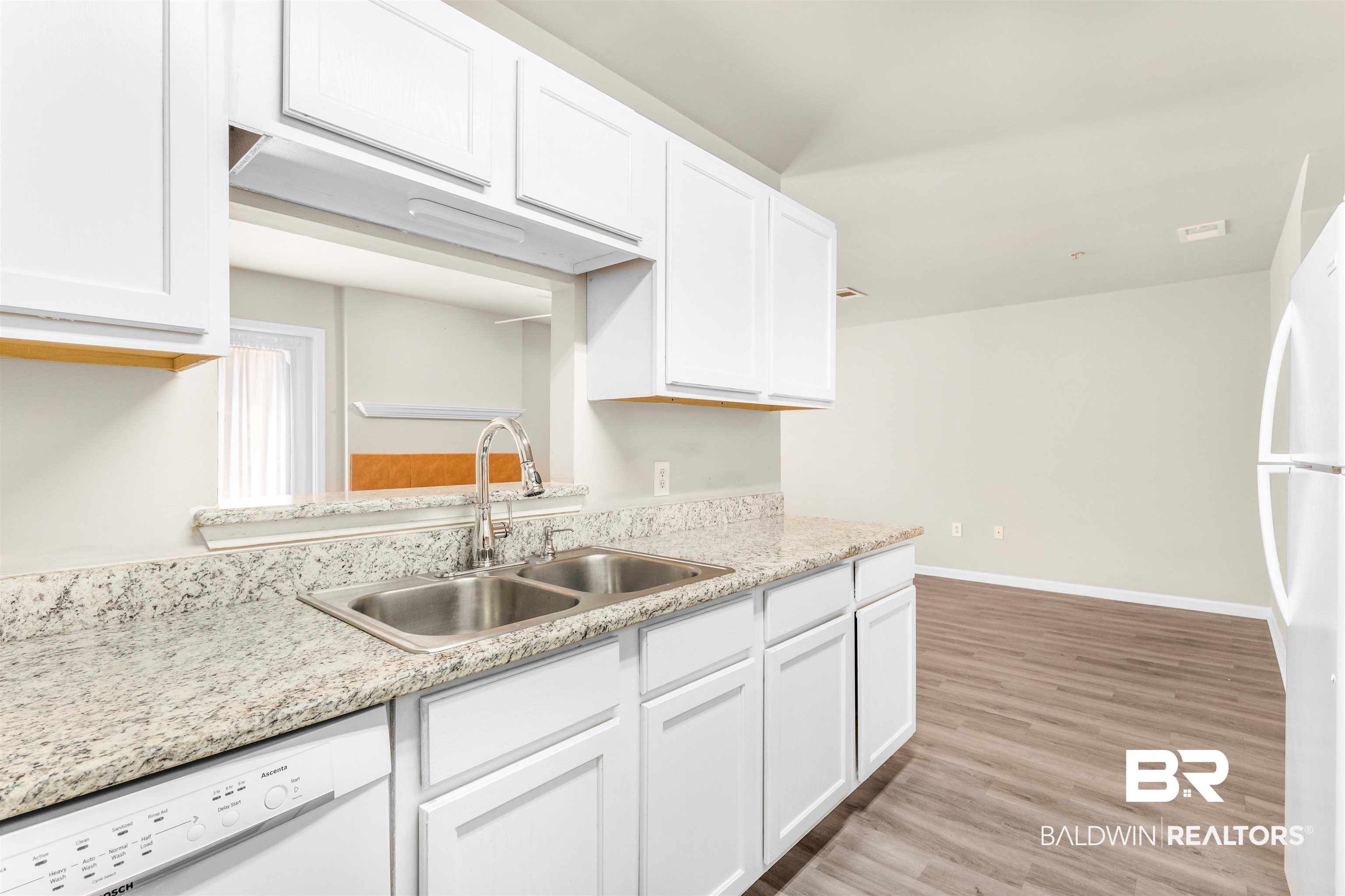 1517 Regency Road, Unit 85 Gulf Shores, AL 36542 - Photo 6 of 32 Kitchen with light hardwood / wood-style floors, sink, white appliances, and white cabinets