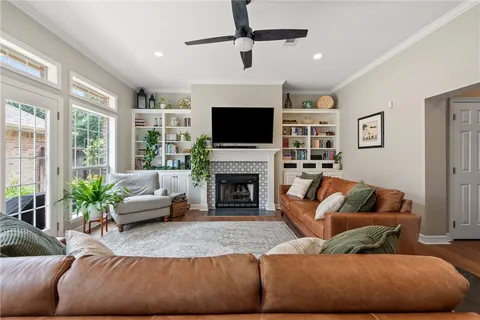 a living room with furniture a fireplace and a flat screen tv
