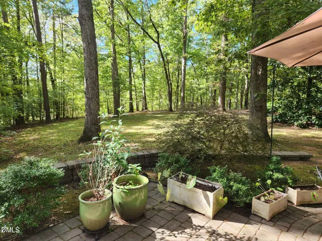 a view of a backyard with sitting area and garden