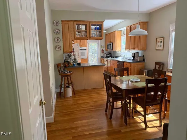 a view of a dining room with furniture and wooden floor