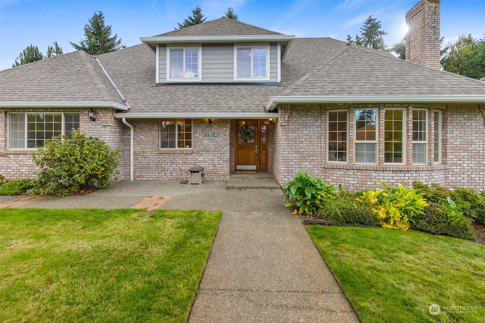a front view of a house with garden