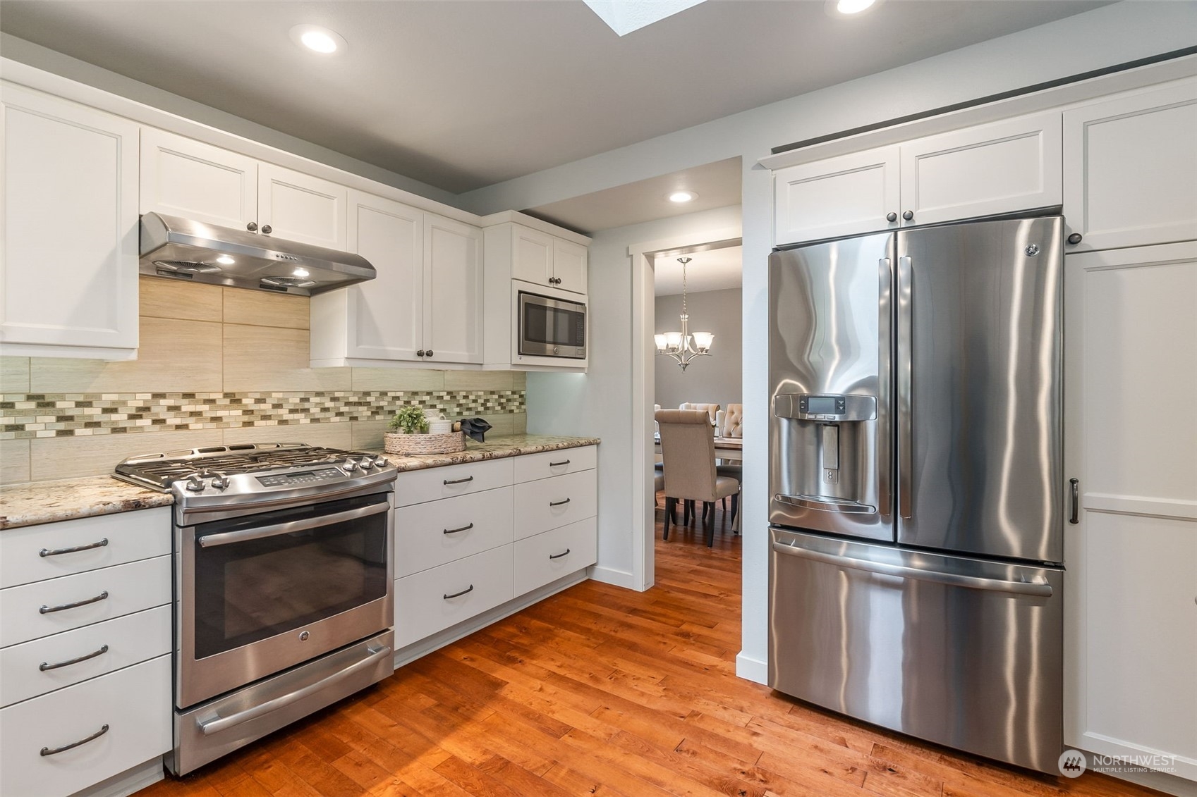 8019 68th Loop Southeast Olympia, WA 98513 - Photo 23 of 40 a kitchen with stainless steel appliances a stove sink and refrigerator