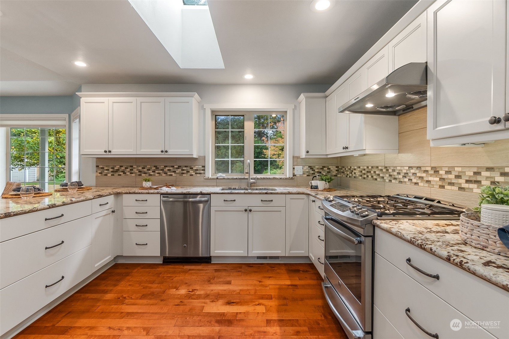 8019 68th Loop Southeast Olympia, WA 98513 - Photo 24 of 40 a kitchen with granite countertop stainless steel appliances a sink stove and cabinets