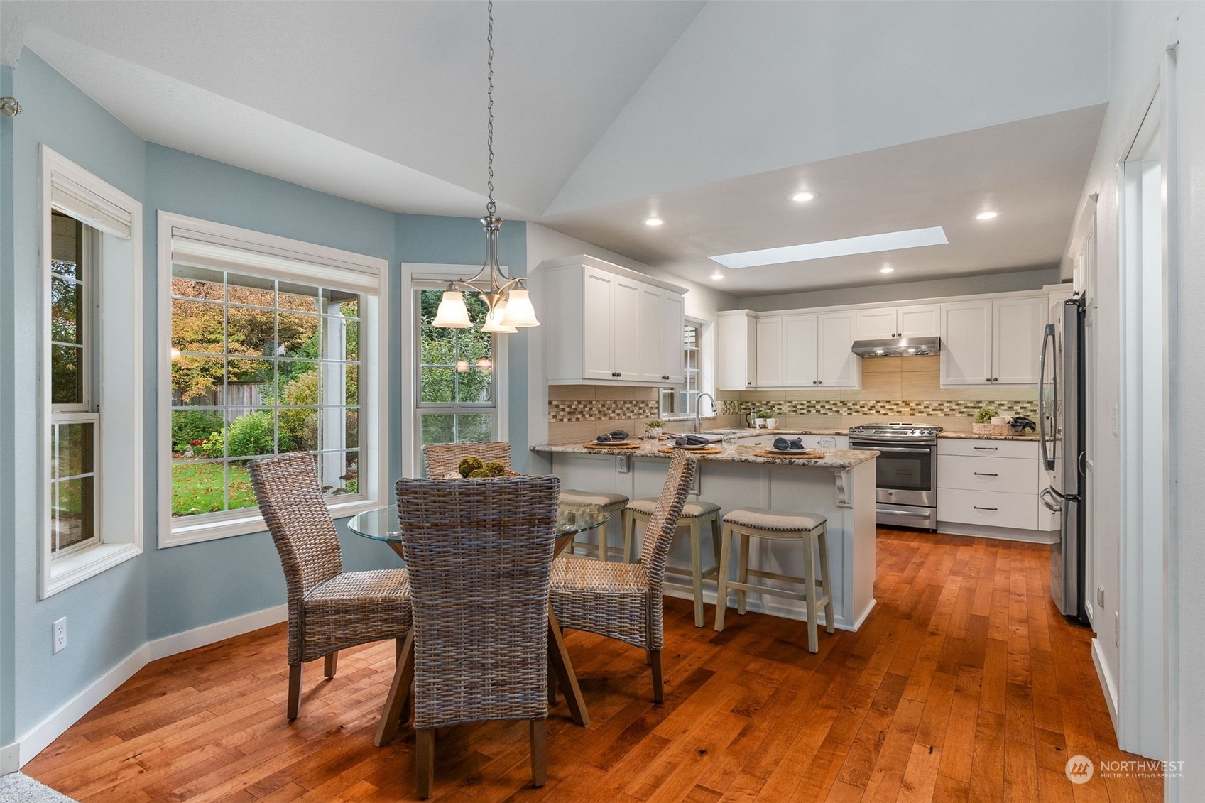 8019 68th Loop Southeast Olympia, WA 98513 - Photo 25 of 40 a view of a dining room with furniture window and wooden floor