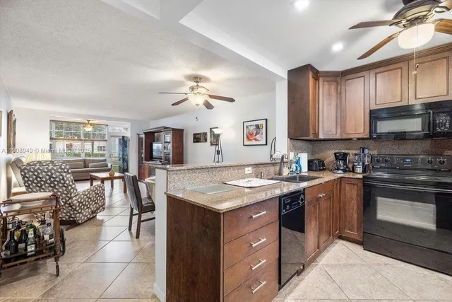 a kitchen with a stove a sink a dining table and chairs