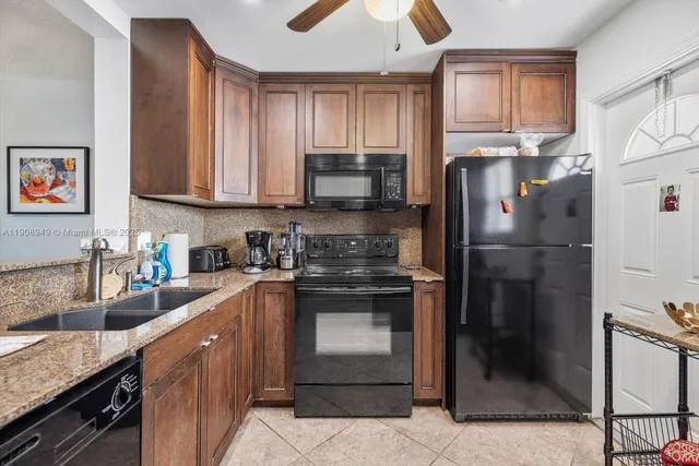 a kitchen with a refrigerator stove and sink