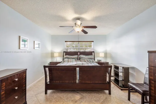 a bed room with a bed and a chandelier