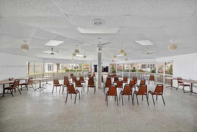 a view of a dining area with lots of furniture and chandelier