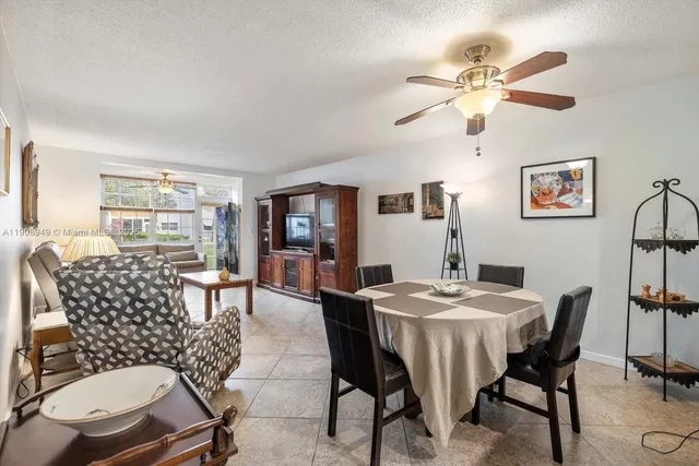 a dining room with furniture a rug and a chandelier