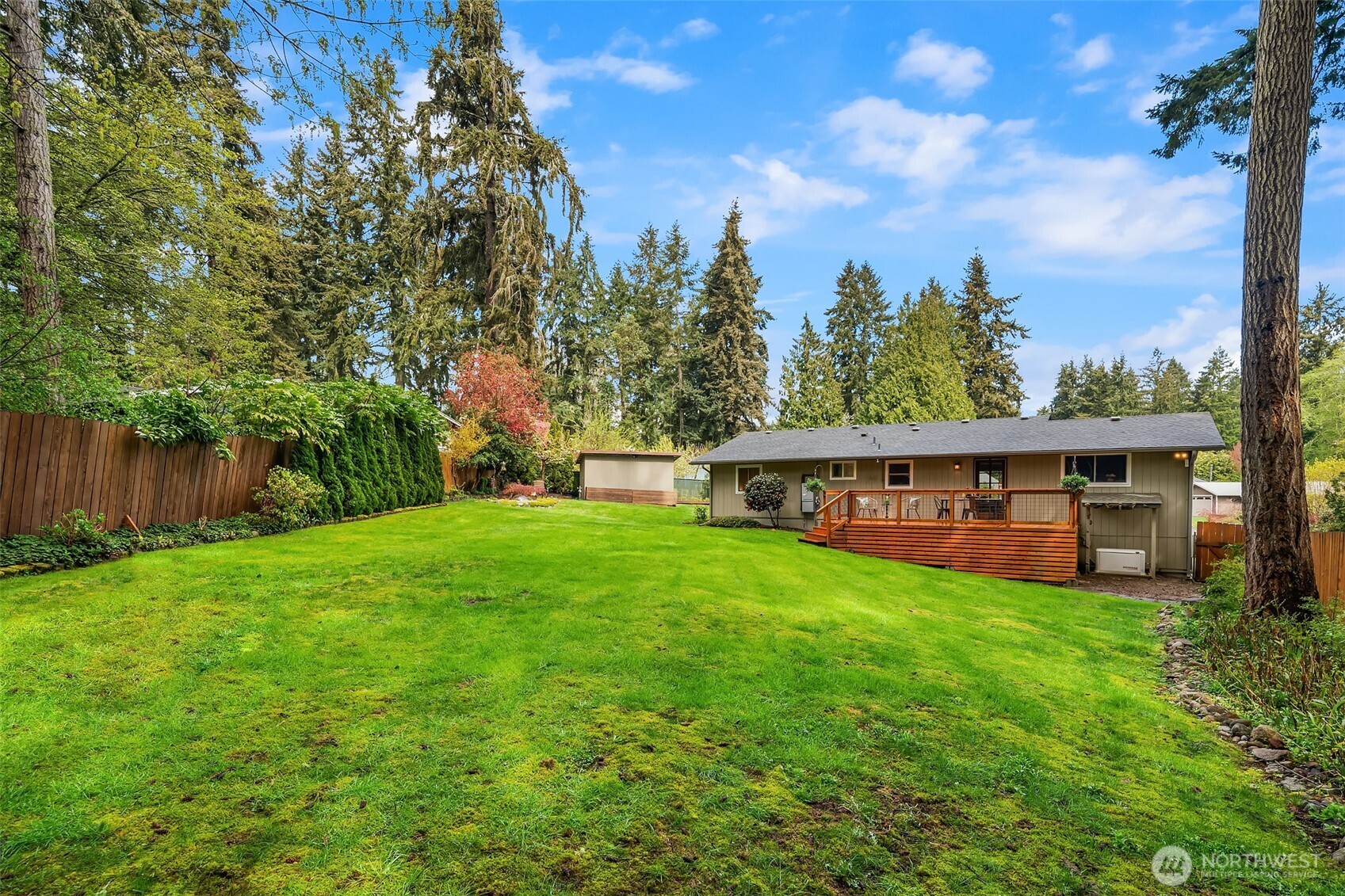 19047 87th Place Southwest Vashon, WA 98070 - Photo 20 of 23 a view of a yard with large trees and wooden fence