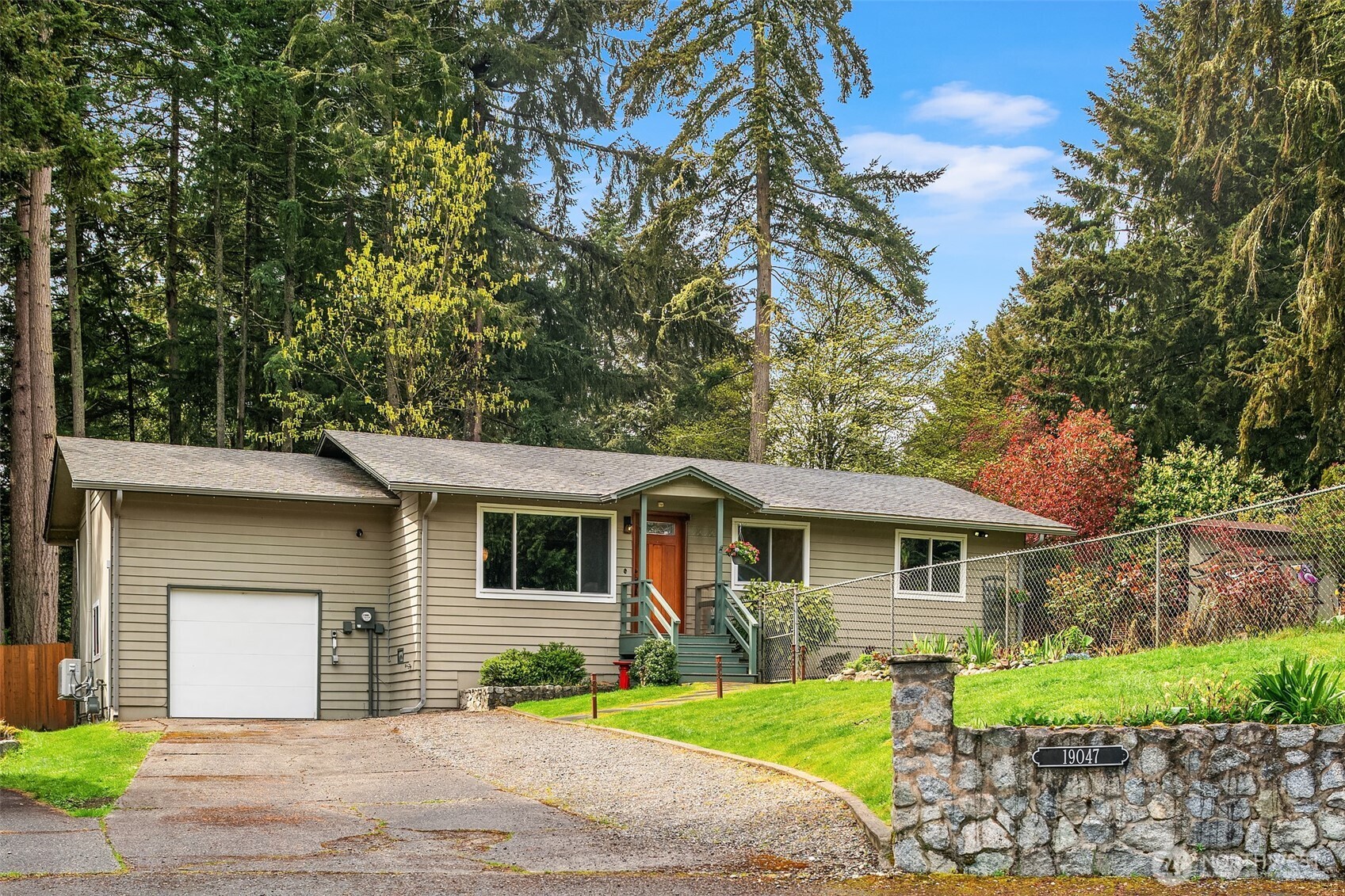 19047 87th Place Southwest Vashon, WA 98070 - Photo 2 of 23 a front view of a house with a yard and trees
