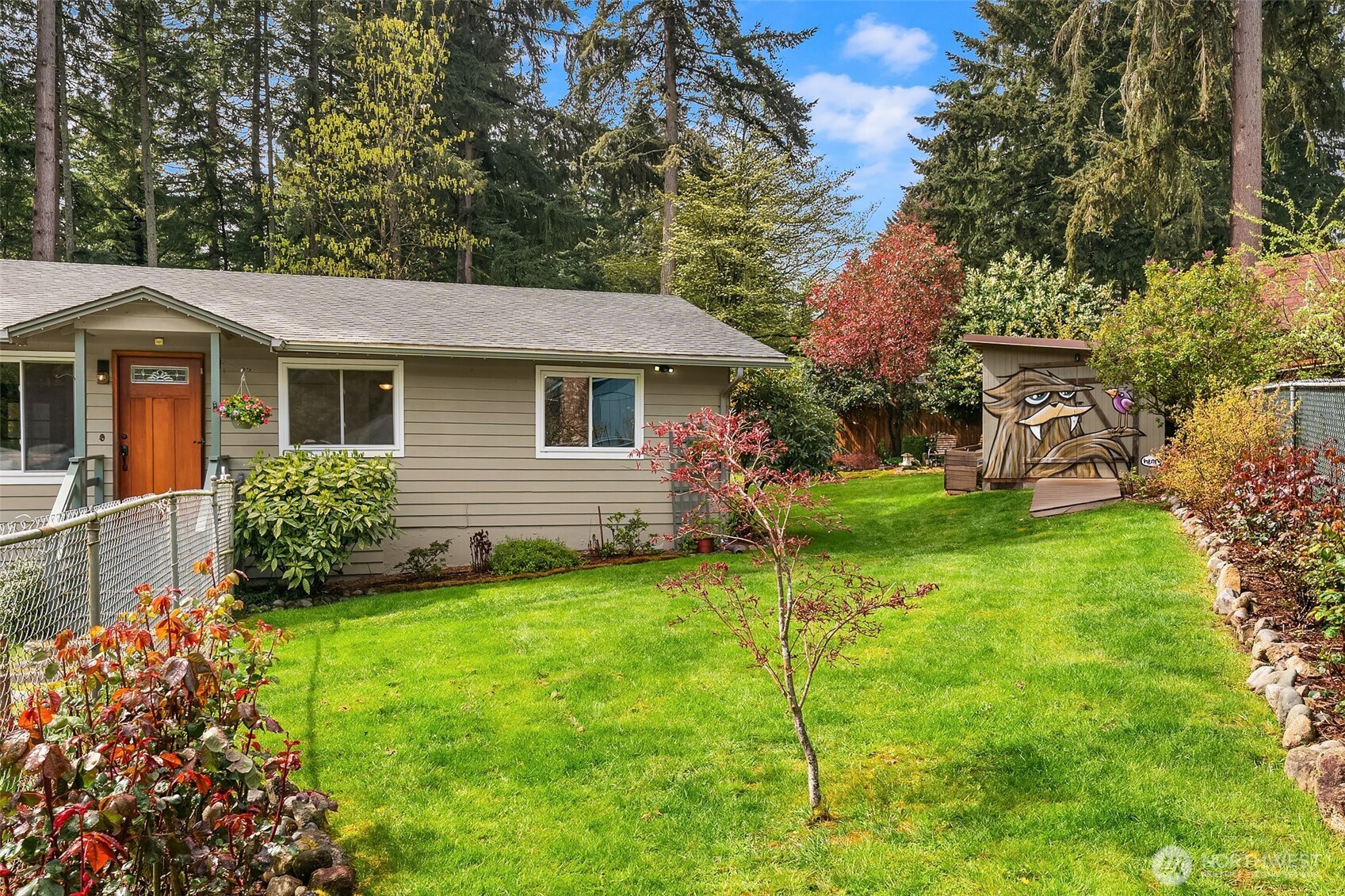 19047 87th Place Southwest Vashon, WA 98070 - Photo 3 of 23 a view of a house with a backyard and a garden