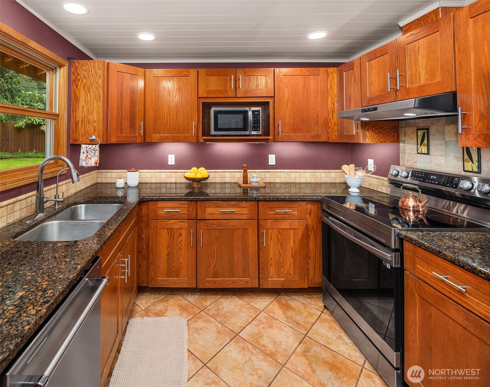 19047 87th Place Southwest Vashon, WA 98070 - Photo 8 of 23 a kitchen with granite countertop a sink a stove top oven a counter space and cabinets