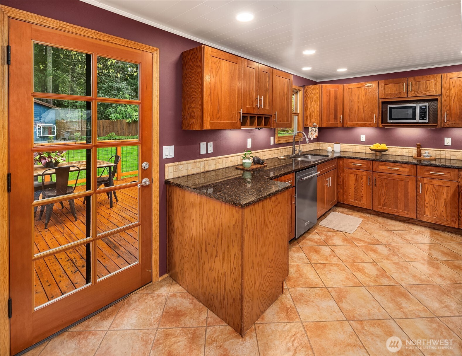 19047 87th Place Southwest Vashon, WA 98070 - Photo 9 of 23 a kitchen with stainless steel appliances granite countertop a refrigerator stove top oven and sink