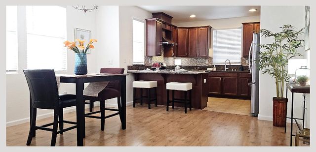 a kitchen with a stove sink and cabinets