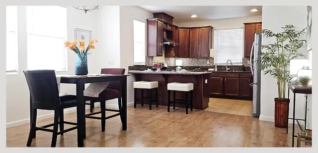 a kitchen with a stove sink and cabinets