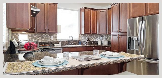a bathroom with a sink vanity tub and a mirror