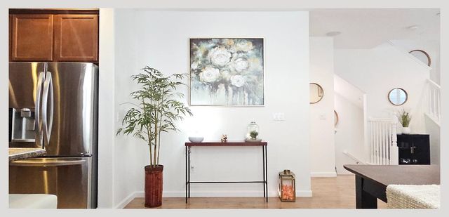 a bathroom with a sink vanity mirror and tub