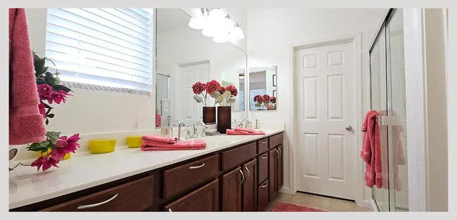 a bathroom with a sink vanity mirror and toilet