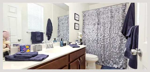 a living room with stainless steel appliances kitchen island granite countertop a sink cabinets and wooden floor