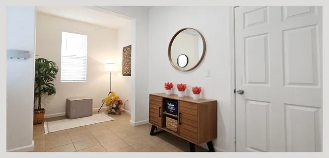 a swimming pool with outdoor seating and trees in the background