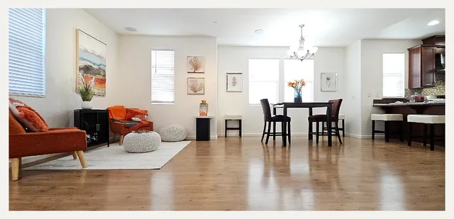 a living room with furniture and wooden floor