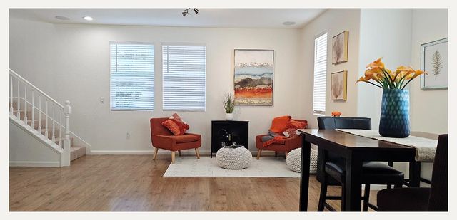a living room with fireplace furniture and a wooden floor
