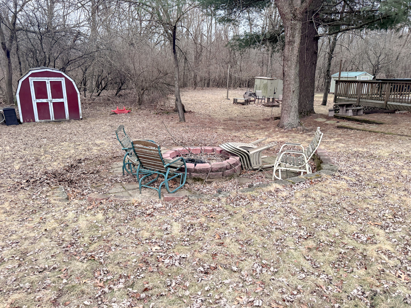 21-70 Woodhaven Sublette, IL 61367 - Photo 3 of 15 a view of a backyard with table and chairs stove and wooden fence