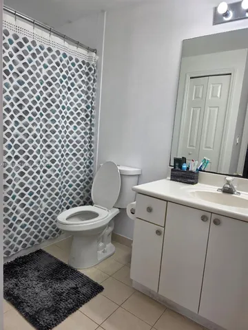 a bathroom with a toilet a sink and a mirror
