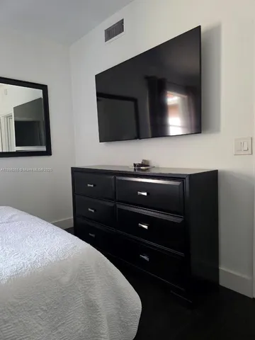 a living room with a flat screen tv and a fireplace