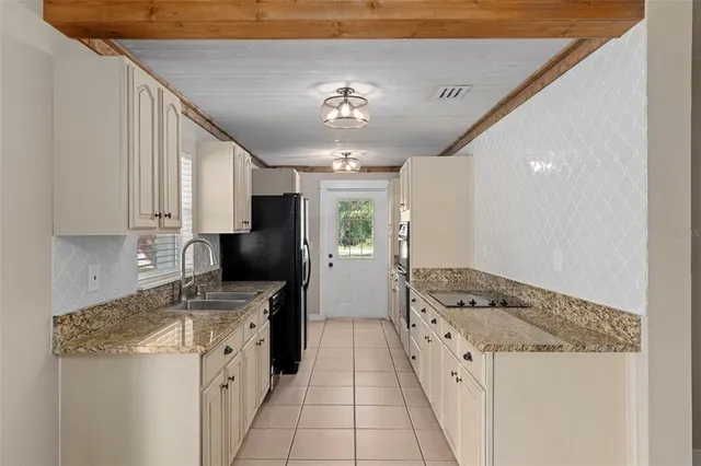 a kitchen with a stove a refrigerator and a sink