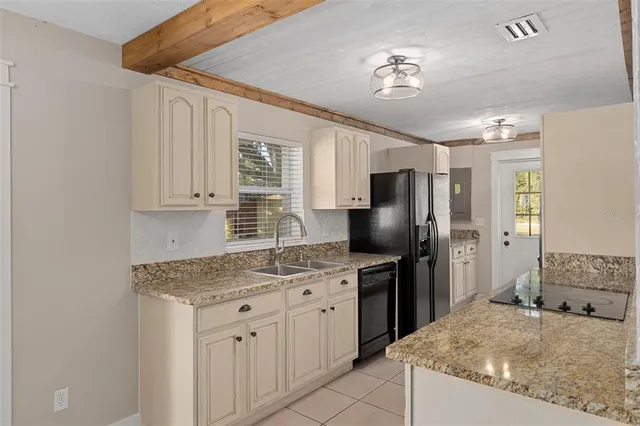 a kitchen with a sink stove and refrigerator