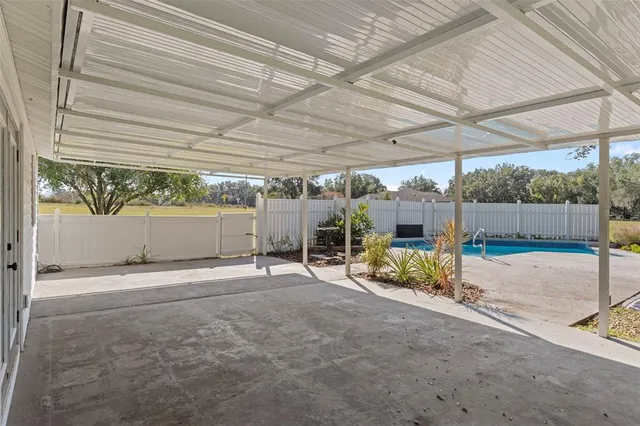 a view of a backyard with wooden fence