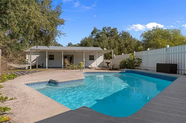 a view of a house with backyard porch and sitting area