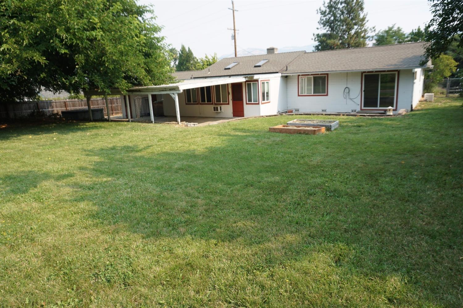 1312 Talent Avenue Talent, OR 97540 - Photo 20 of 21 a front view of a house with a garden and trees