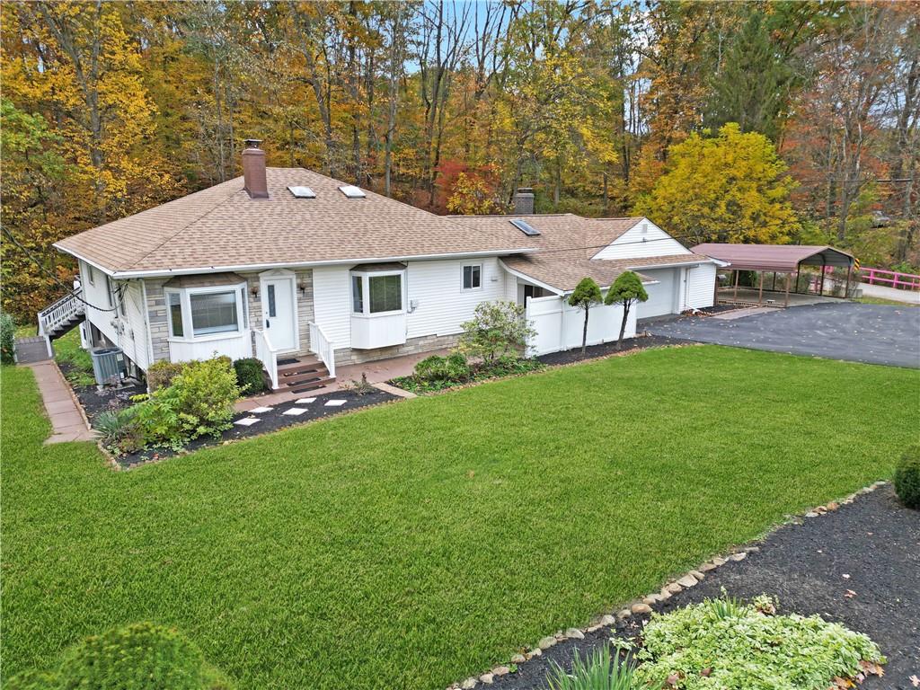 a aerial view of a house with a yard porch and sitting area