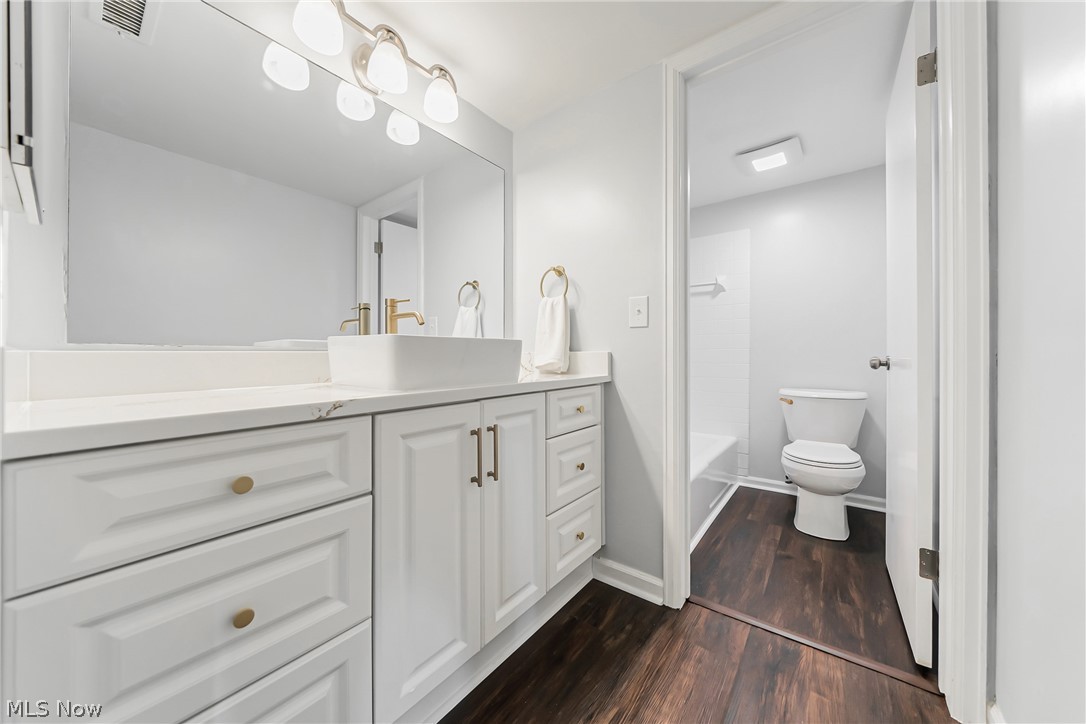22701 Center Ridge Road, Unit 304 Rocky River, OH 44116 - Photo 19 of 31 Full bathroom with hardwood / wood-style flooring, toilet, vanity, and shower / tub combination